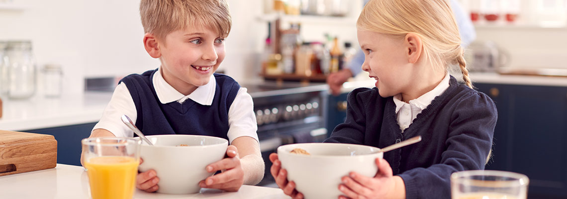 Kids smiling with breakfast
