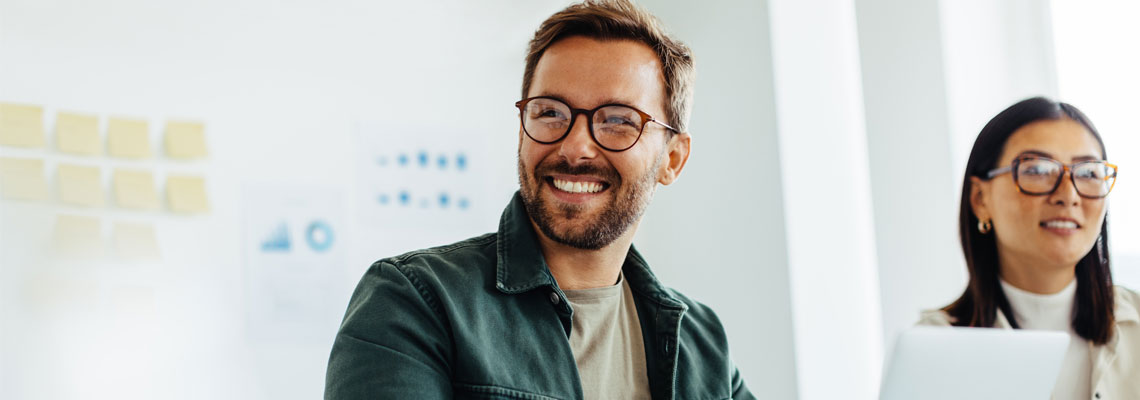 Business professional sitting in a meeting with his colleagues
