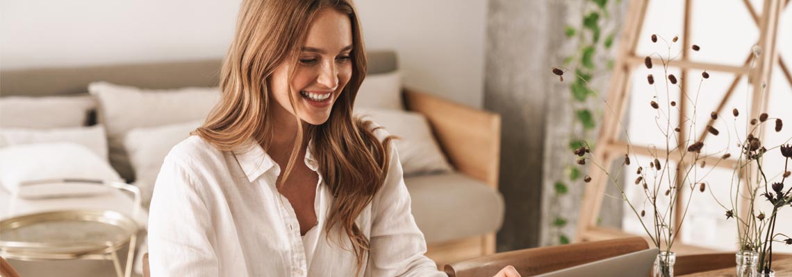 business woman sit indoors in office using laptop