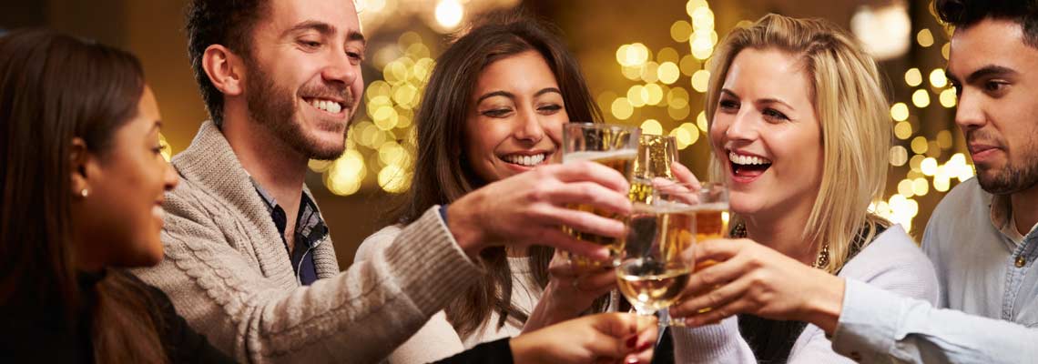 Group of friends enjoying evening drinks in bar