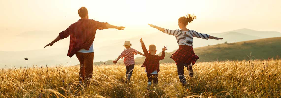 family running through the fields