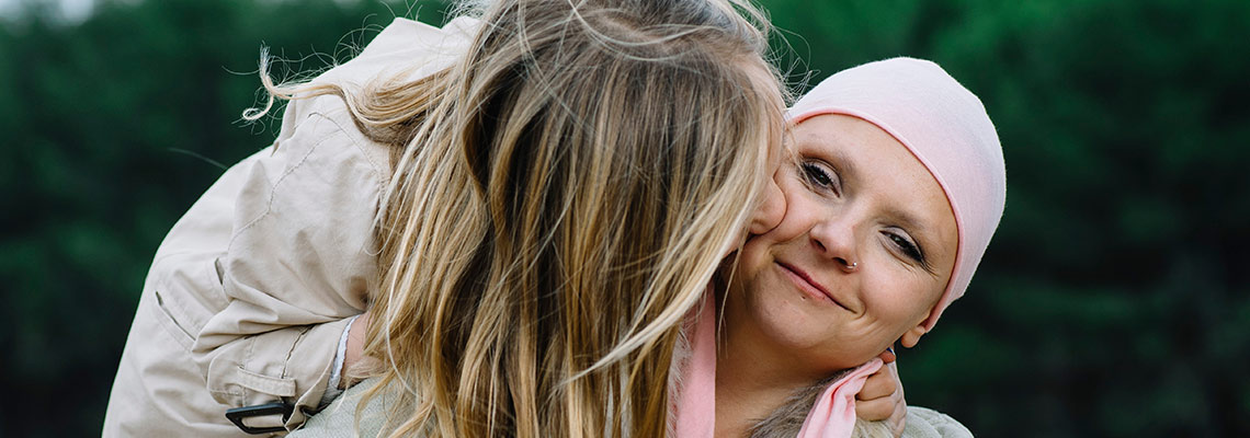 Daughter hugging her mother with cancer