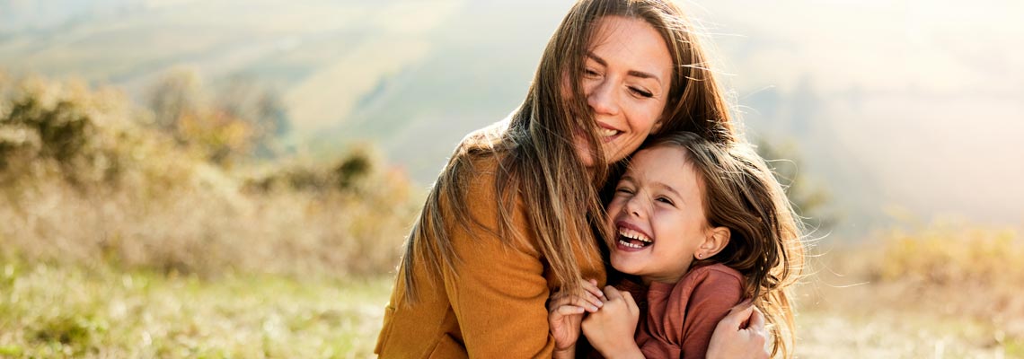 mother and daughter hugging and smiling