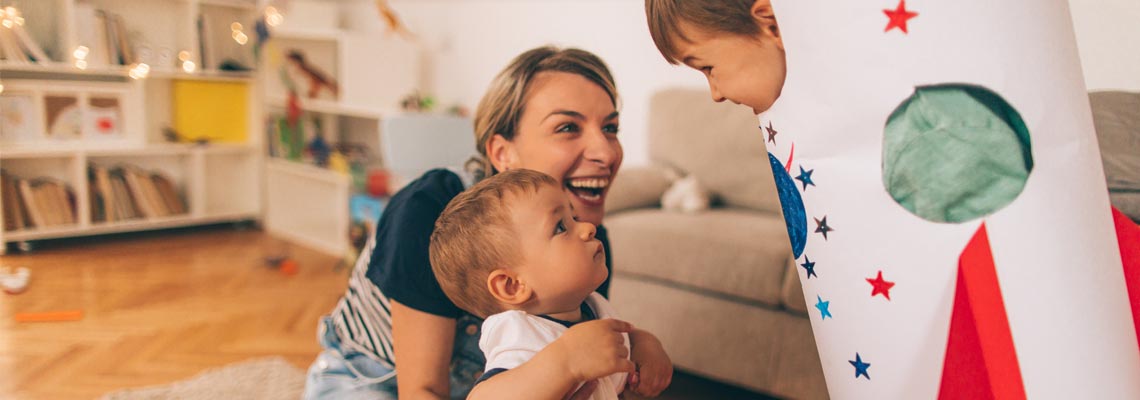 Smiling mum with two kids playing