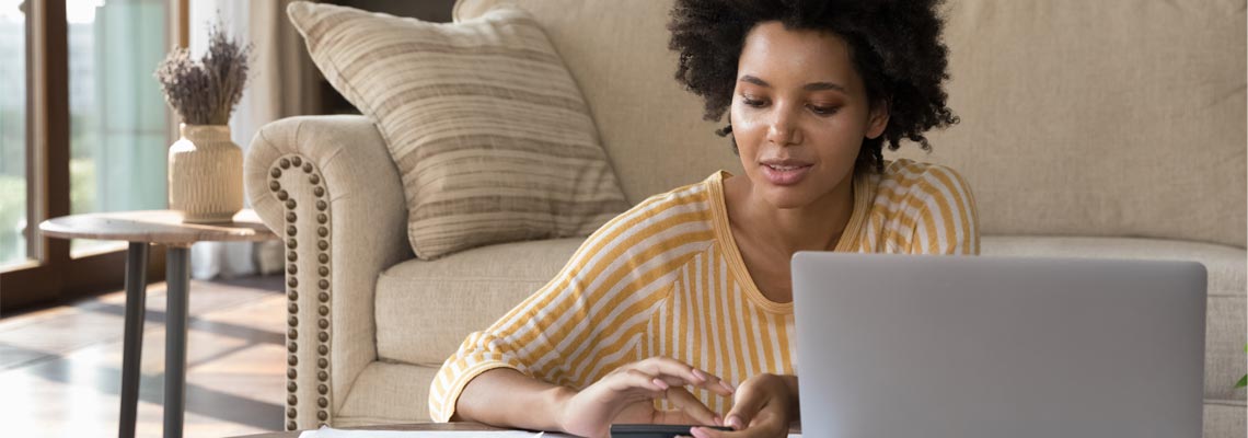 woman using laptop in her living room