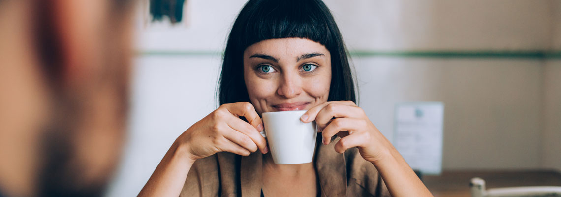 smiling woman drinking coffee