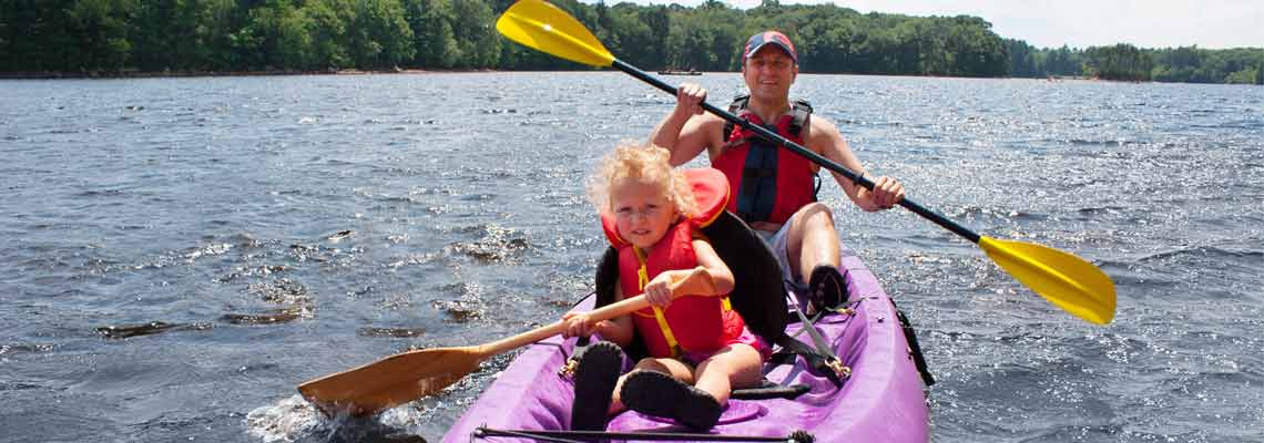 father and daughter kayaking