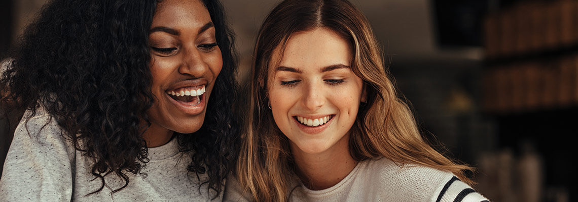 Two young women smiling together