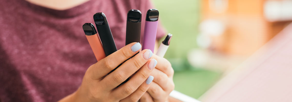 young person holding vapes