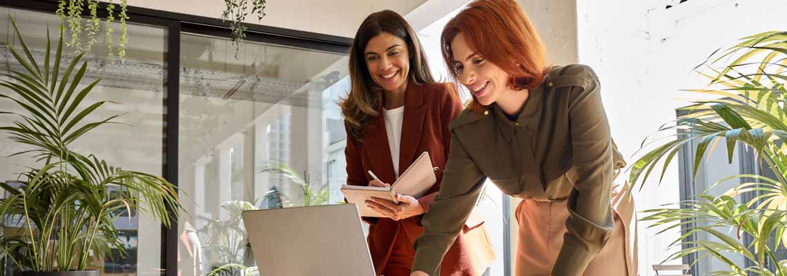two business women in the office talking
