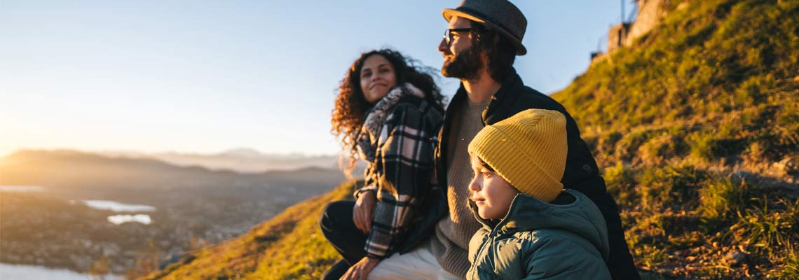 smiling family on the hill
