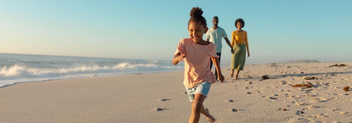 happy family running on the beach
